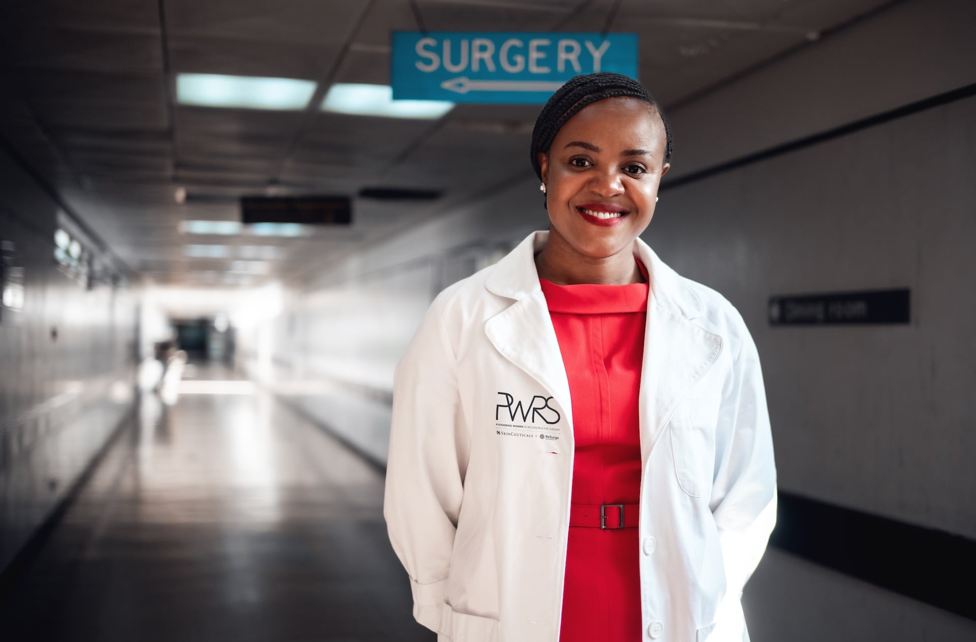 Dr. Thandi smiling in a hospital hallway
